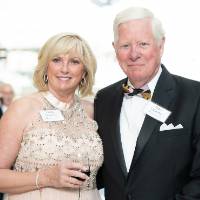 Couple posing, holding drinks at Enrichment.